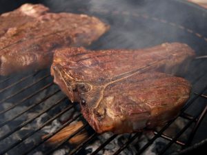 t-bone steaks on grill